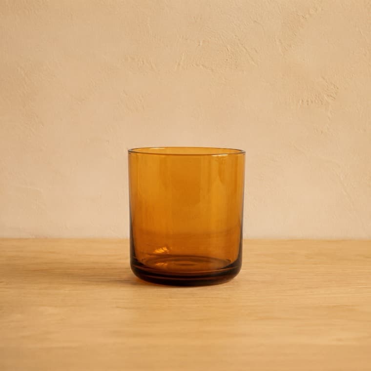 Water Glass 250 ml in amber, photographed under warm indoor: domestic tungsten lighting, about 2700 k.